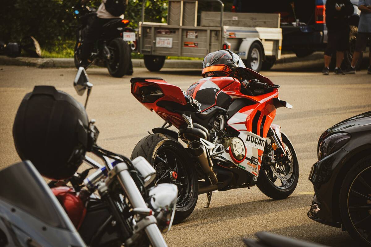 Red and white motorcycle parked on asphalt