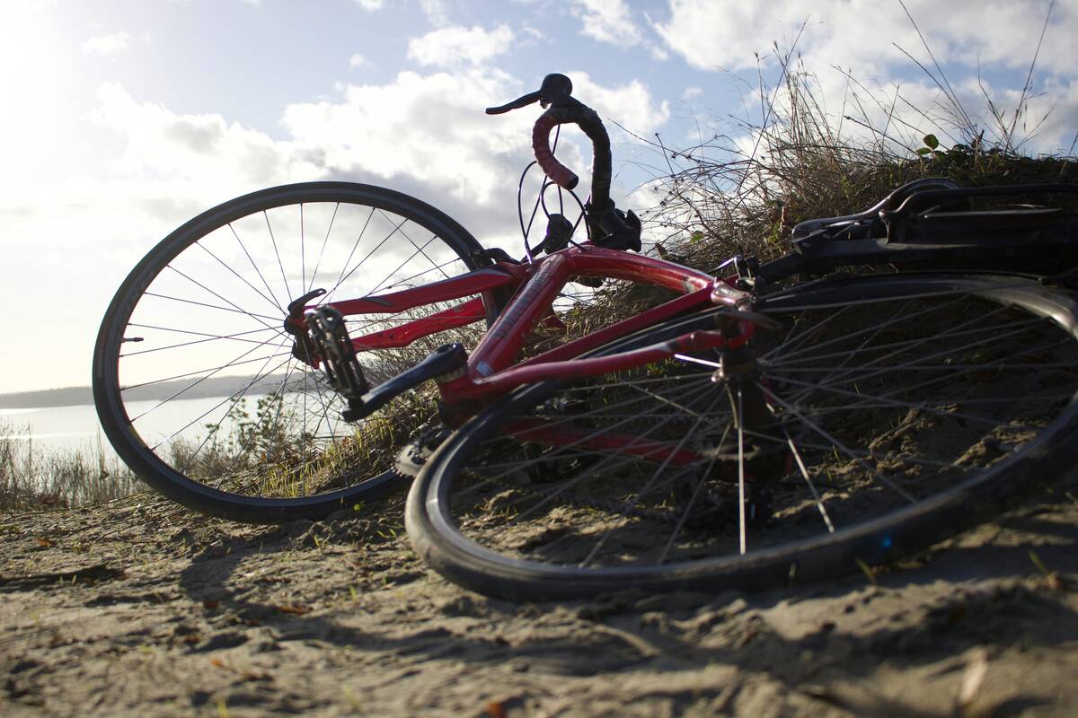 A person standing on a bike