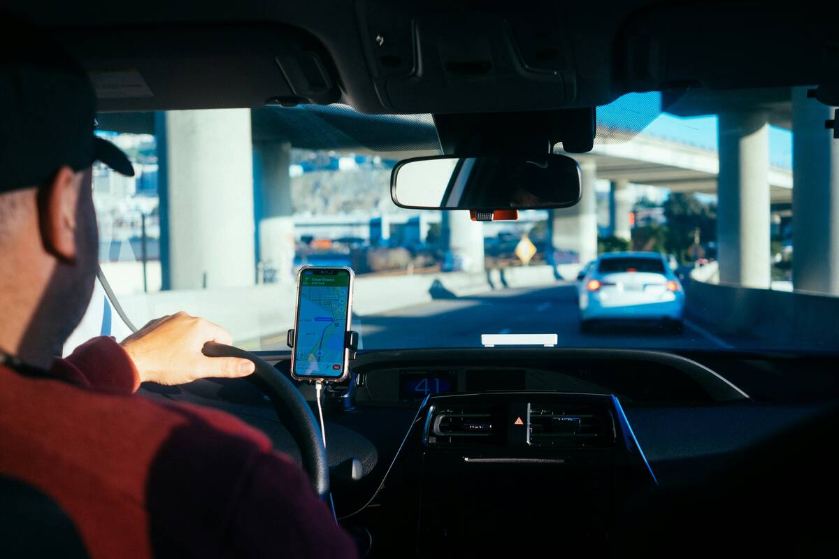Person driving a car with a navigation app
