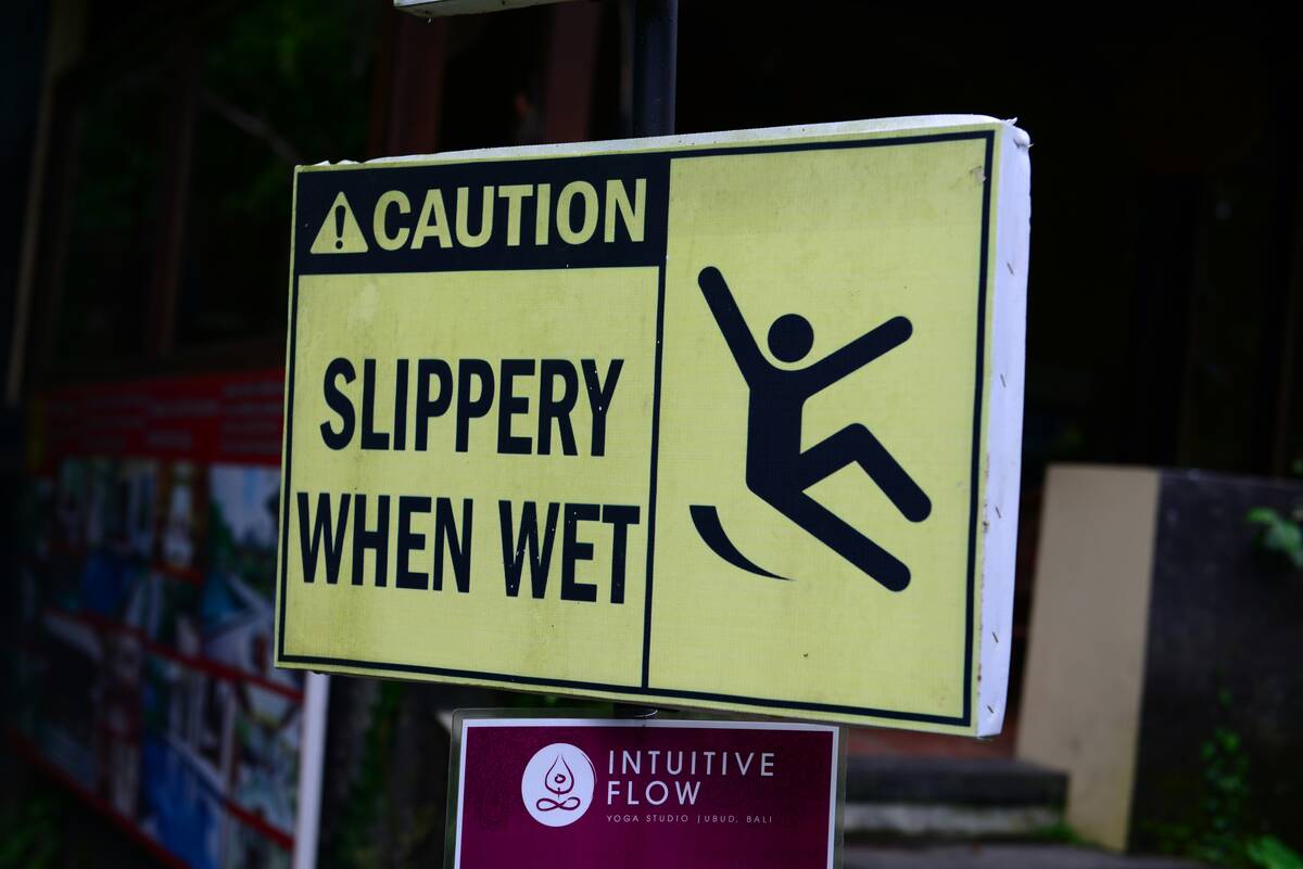 White and black wet floor caution sign